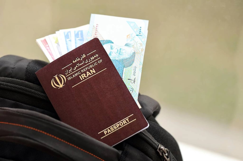 Red Islamic Republic Of Iran Passport With Money And Airline Tickets On Touristic Backpack Close Up