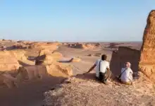 Tourists Watch The Sun Go Down Over Yardangs In The Lut Desert In Shahad, Ian