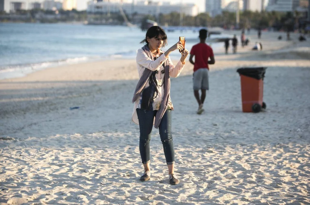 A Woman Takes Pictures On The Beach In Kish Island, Southern Iran